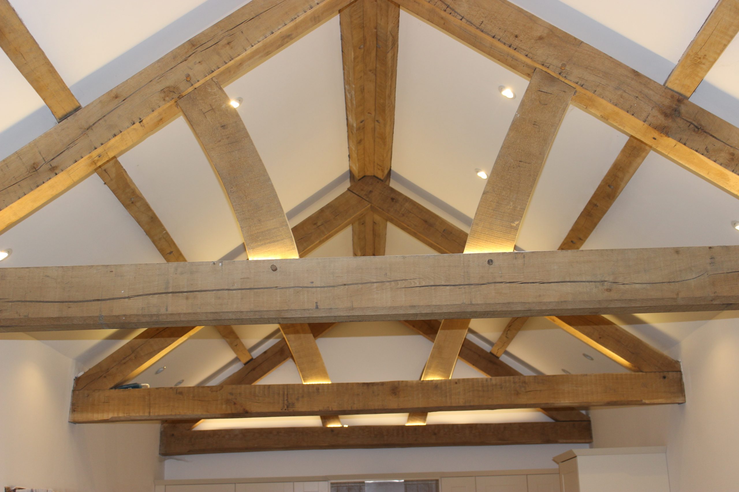 feature green oak queen post trusses and purlins in a barn conversion