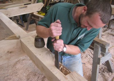 timber frame being hand crafted with traditional tools in Devon
