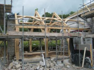 sling brace timber framed house extension being built in devon