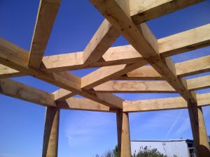 timber framed flat roof structure with huge green oak floor joists for garden room observatory