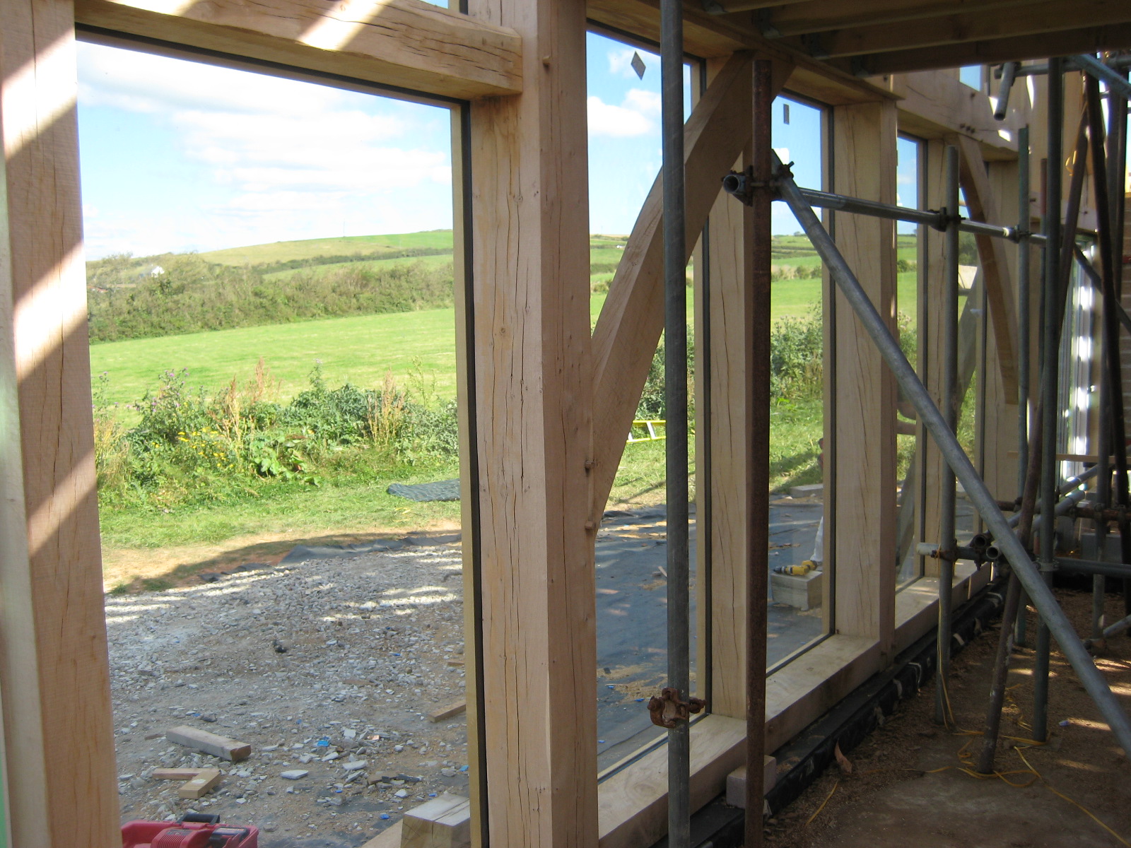 looking out through the direct glazed windows of a green oak timber frame