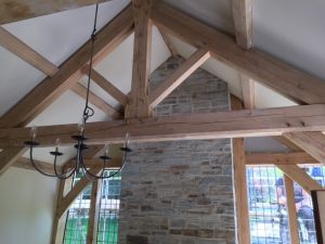 Feature jointed and pegged green oak king post trusses with oak purlins
