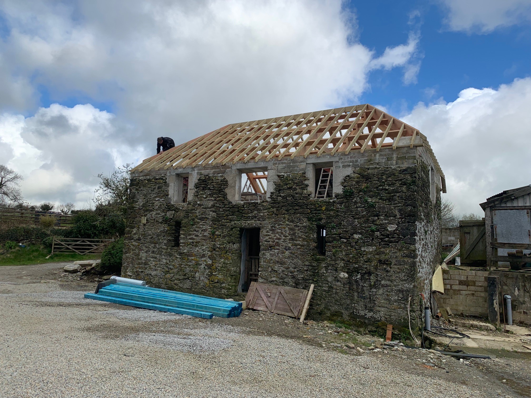 barn conversion in cornwall with a timber framed roof being built