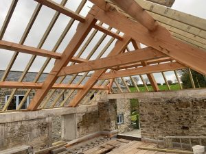 Douglas fir vaulted roof barn conversion during construction on a rainy day in Cornwall
